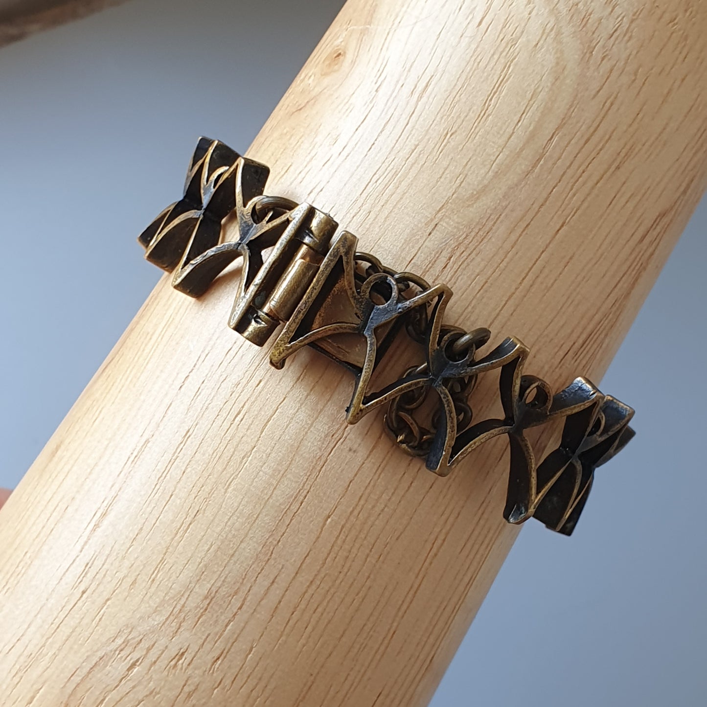 Intricate bronze bracelet with an abstract geometric design.