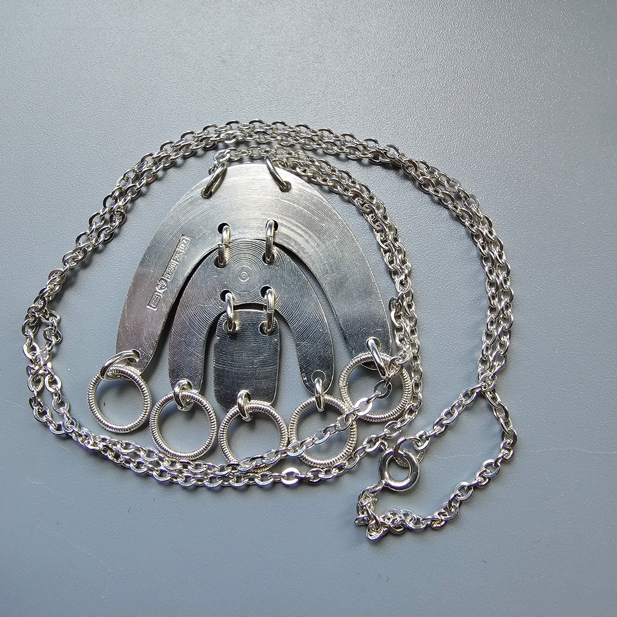 Metal chastity belt with attached chain.