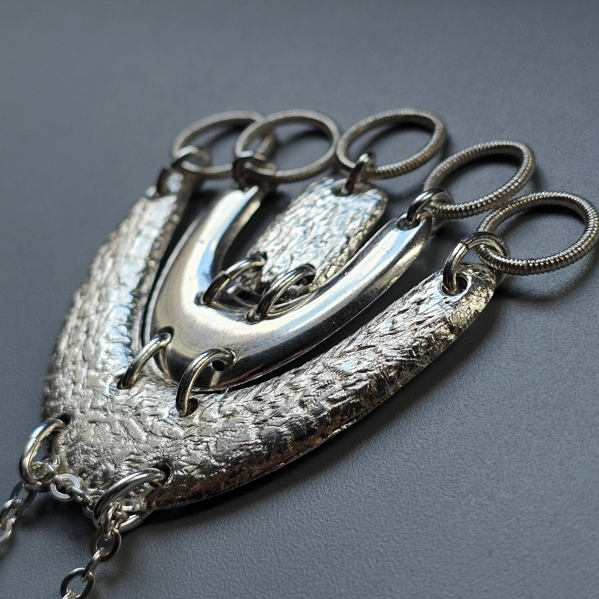 Ornate silver chatelaine with multiple scissor attachments.