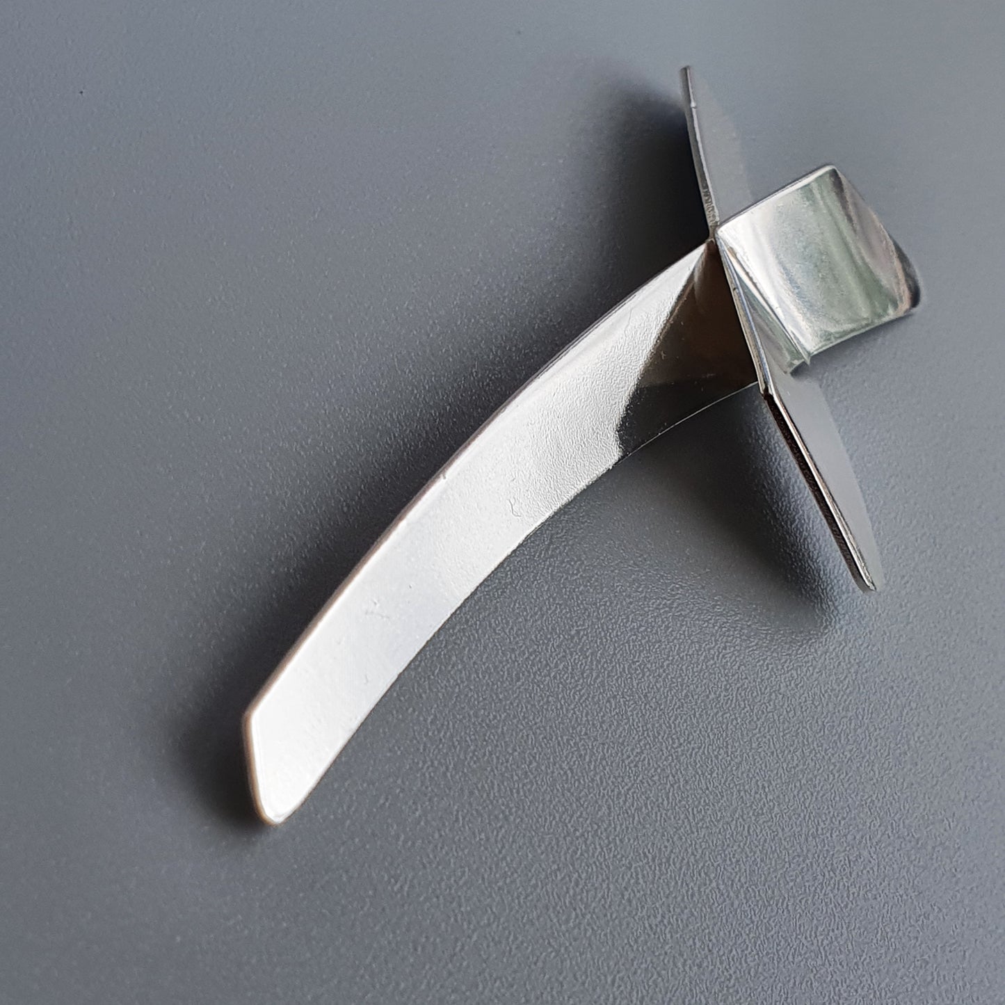 Sleek, modern letter opener with a curved handle and sharp blade.