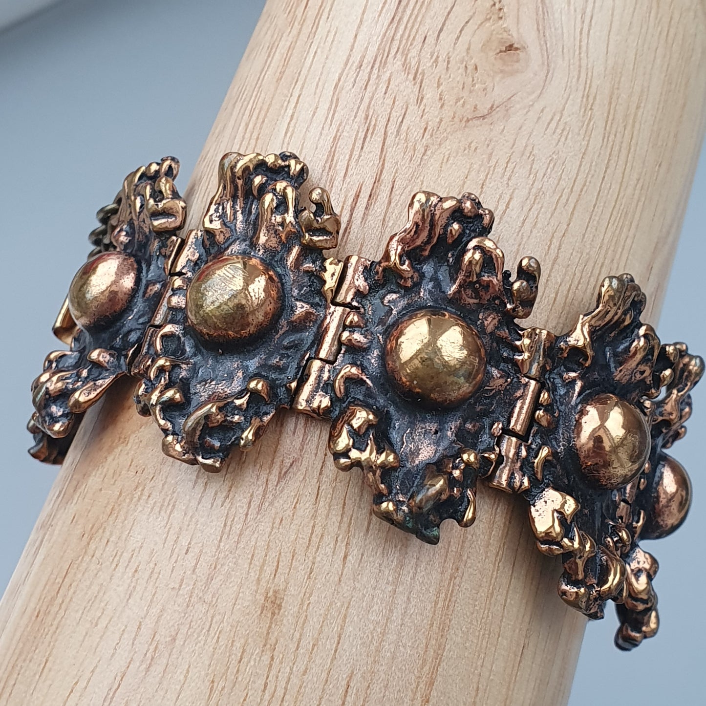 Ornate vintage-style bracelet with gold-toned spherical accents and intricate metalwork.