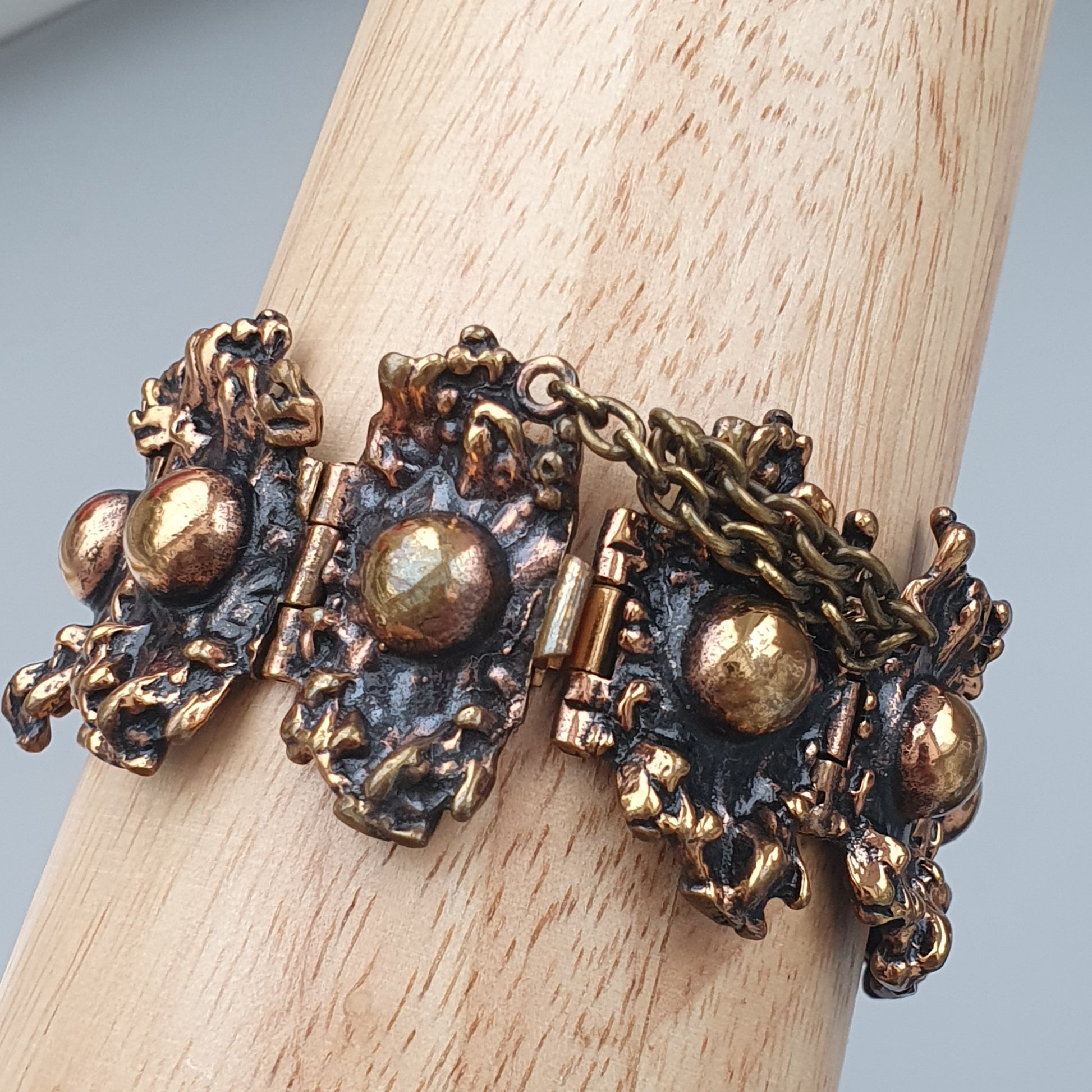 Ornate vintage-style bracelet with intricate metalwork and spherical details.