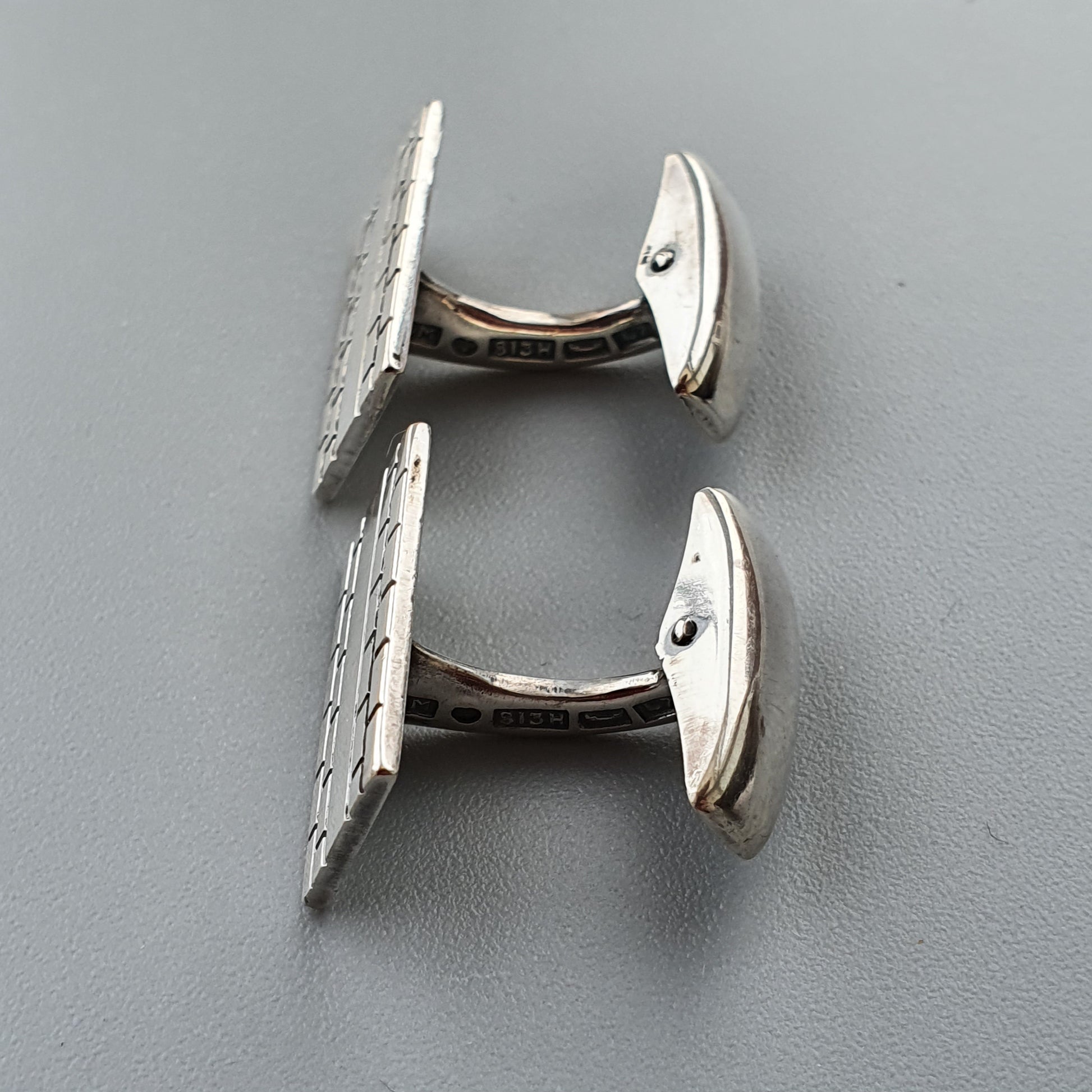 Pair of silver cufflinks with textured oval faces.