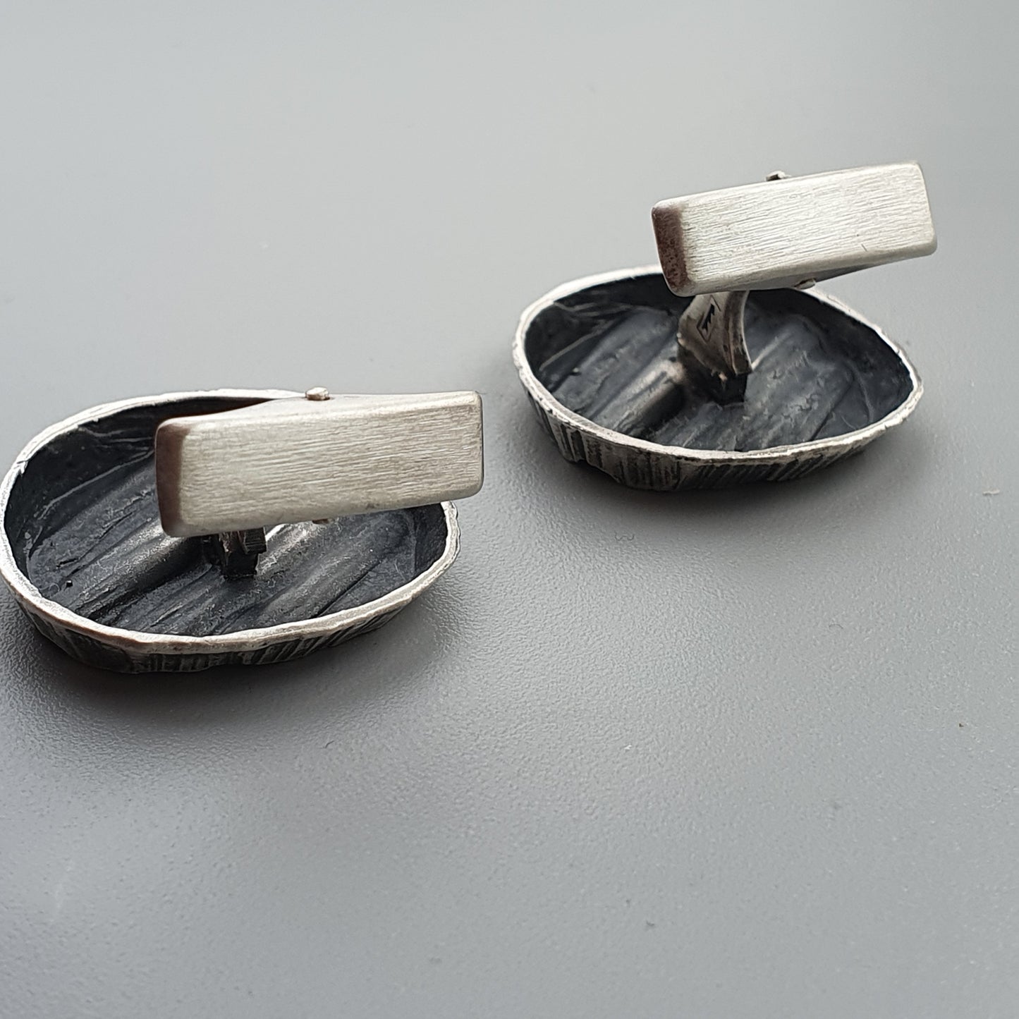 Pair of vintage-style metal ashtrays with wooden handles.