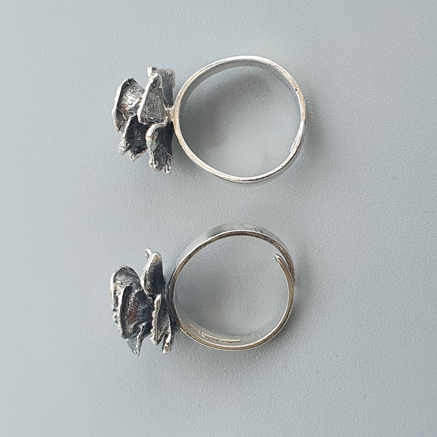 Silver rings featuring decorative bird-shaped designs on top.