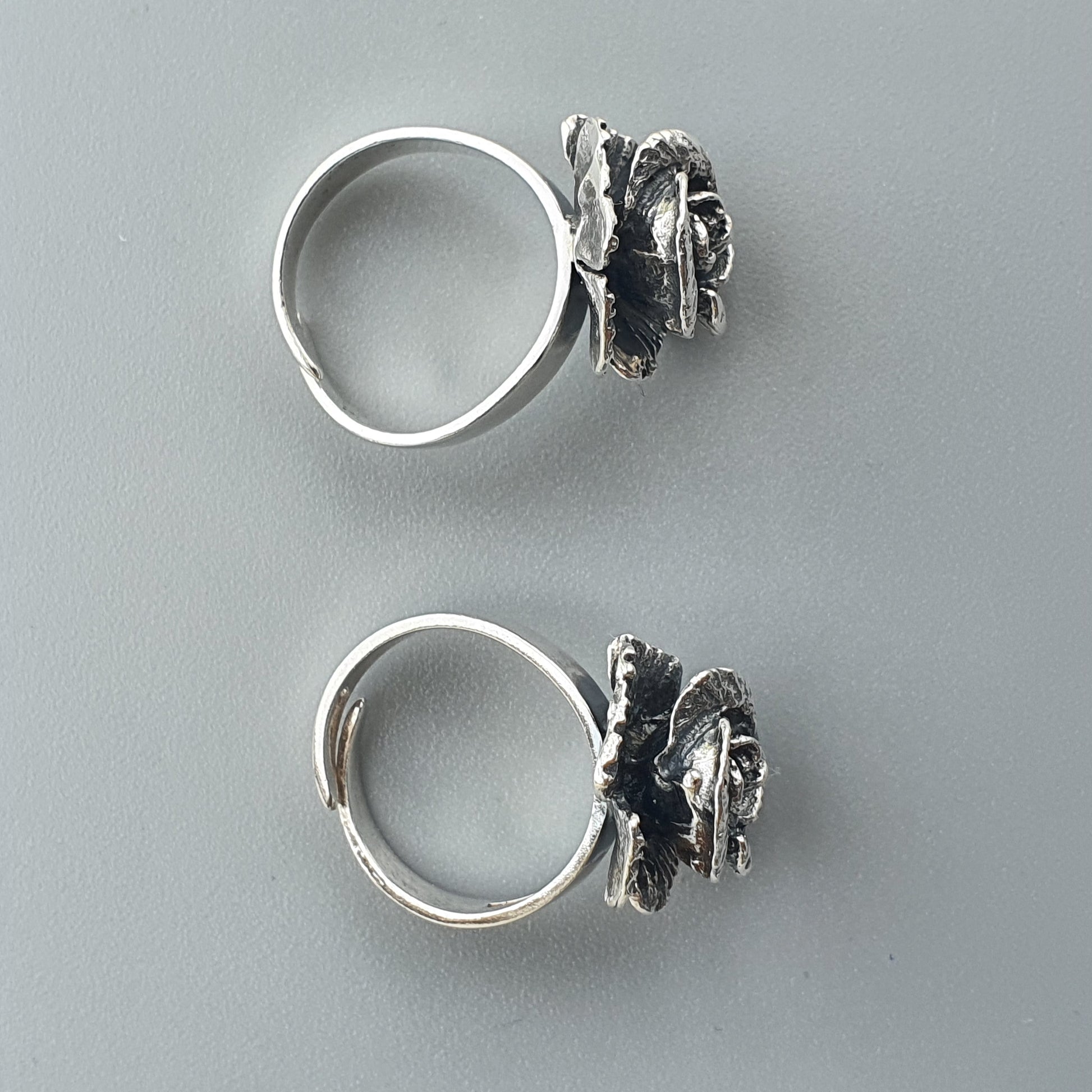 Silver rings with decorative butterfly-shaped attachments.