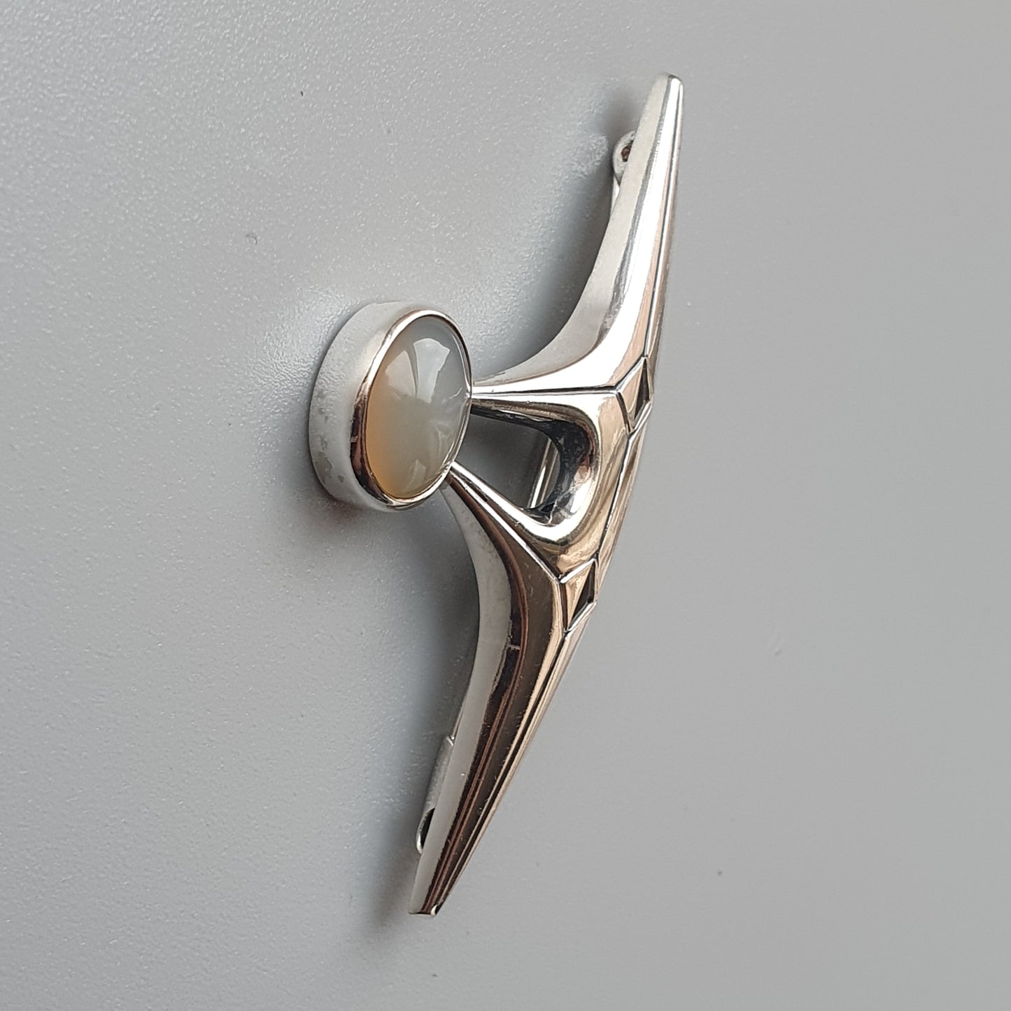 Shiny metallic door handle or lever with a sleek, modern design.