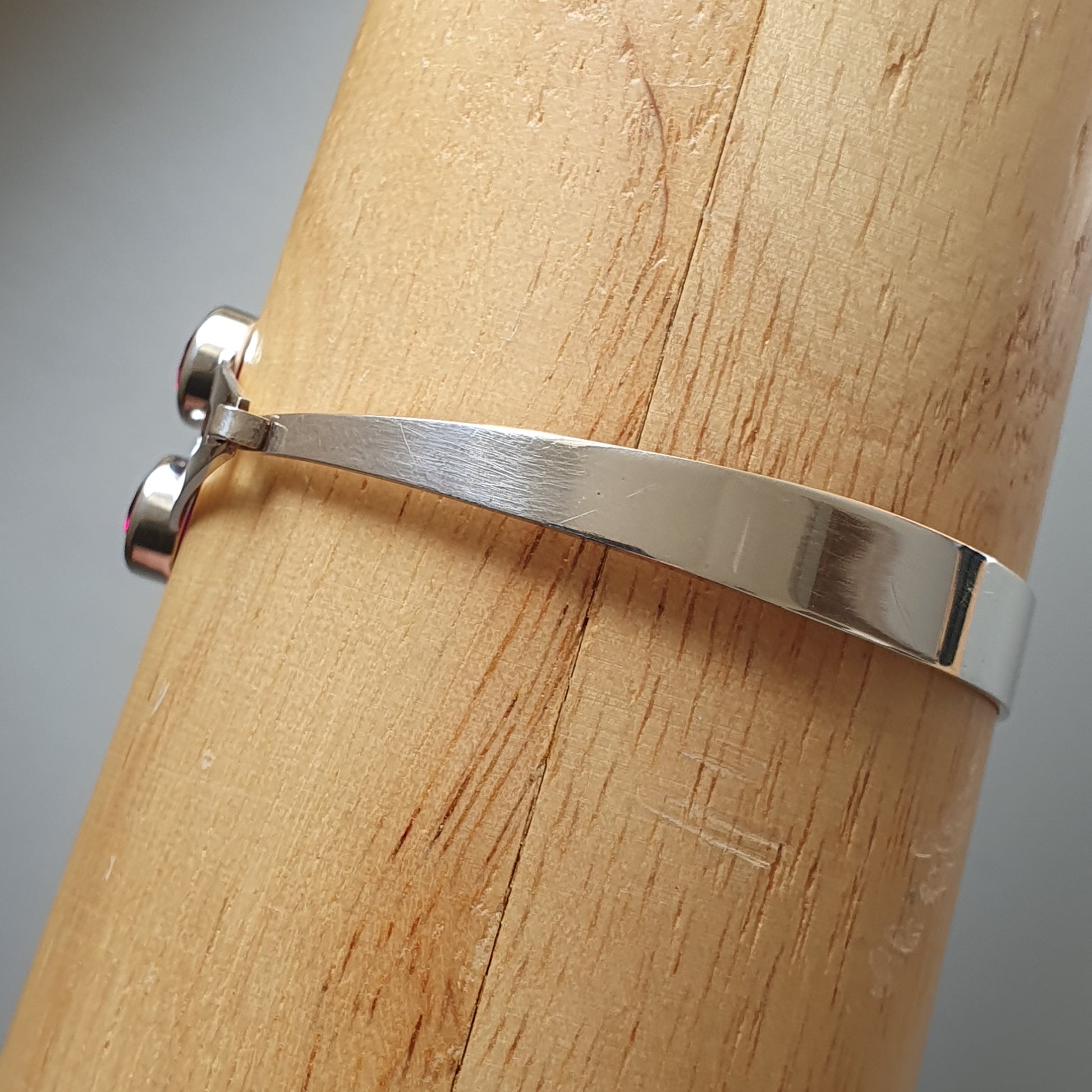 Silver metal bracelet or bangle with a simple, sleek design.