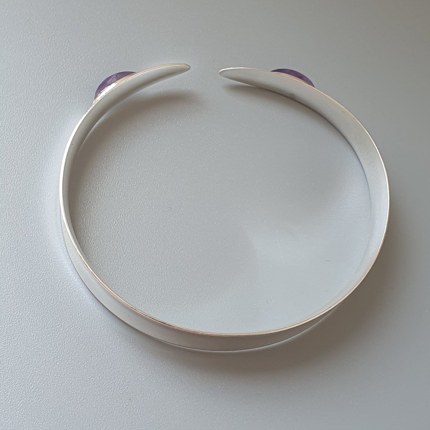 White plastic headband with purple accents at the ends.