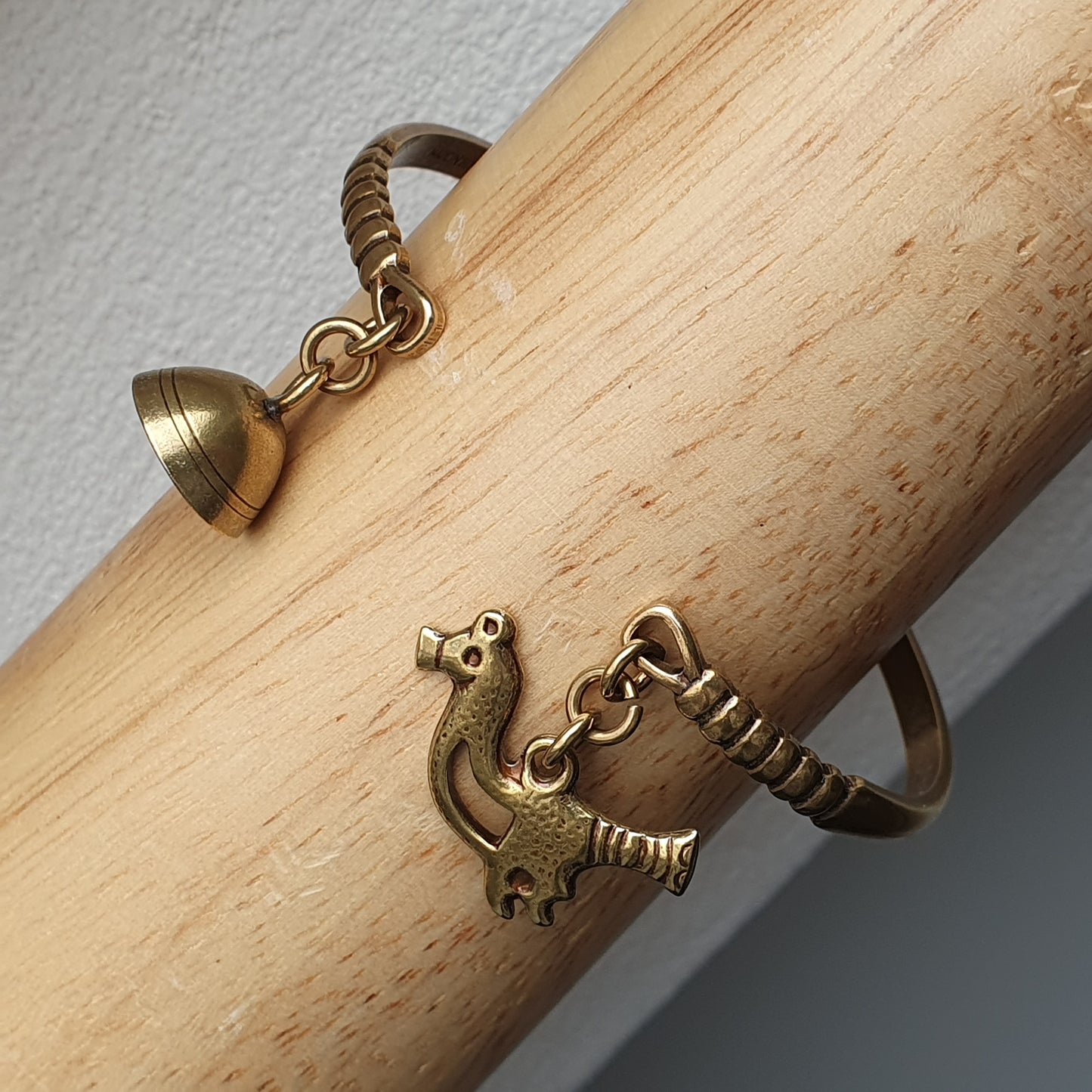 Brass or bronze bracelet shaped like a stylized dinosaur or dragon.