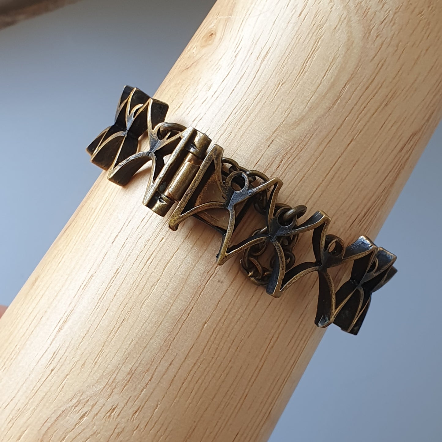 Intricate bronze bracelet with an abstract geometric design.