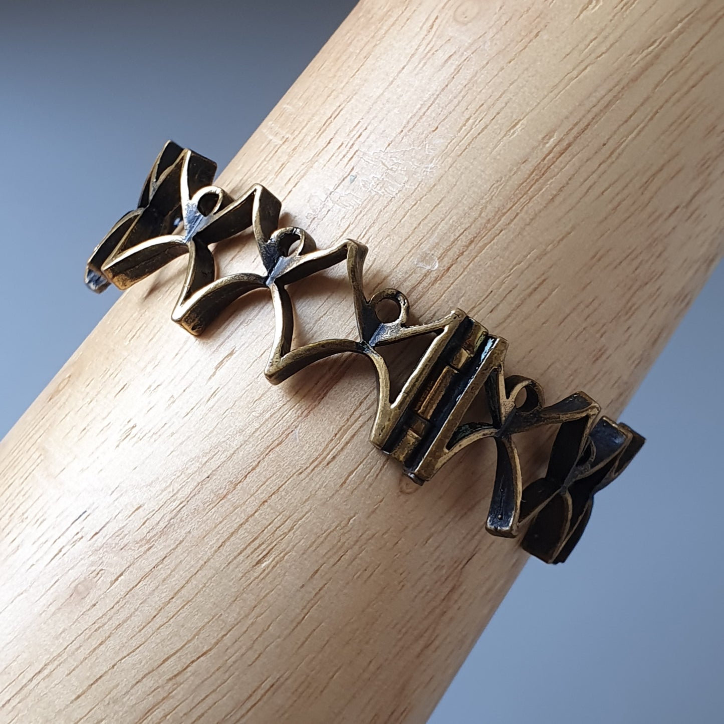 Intricately designed metal bracelet with a zigzag pattern.