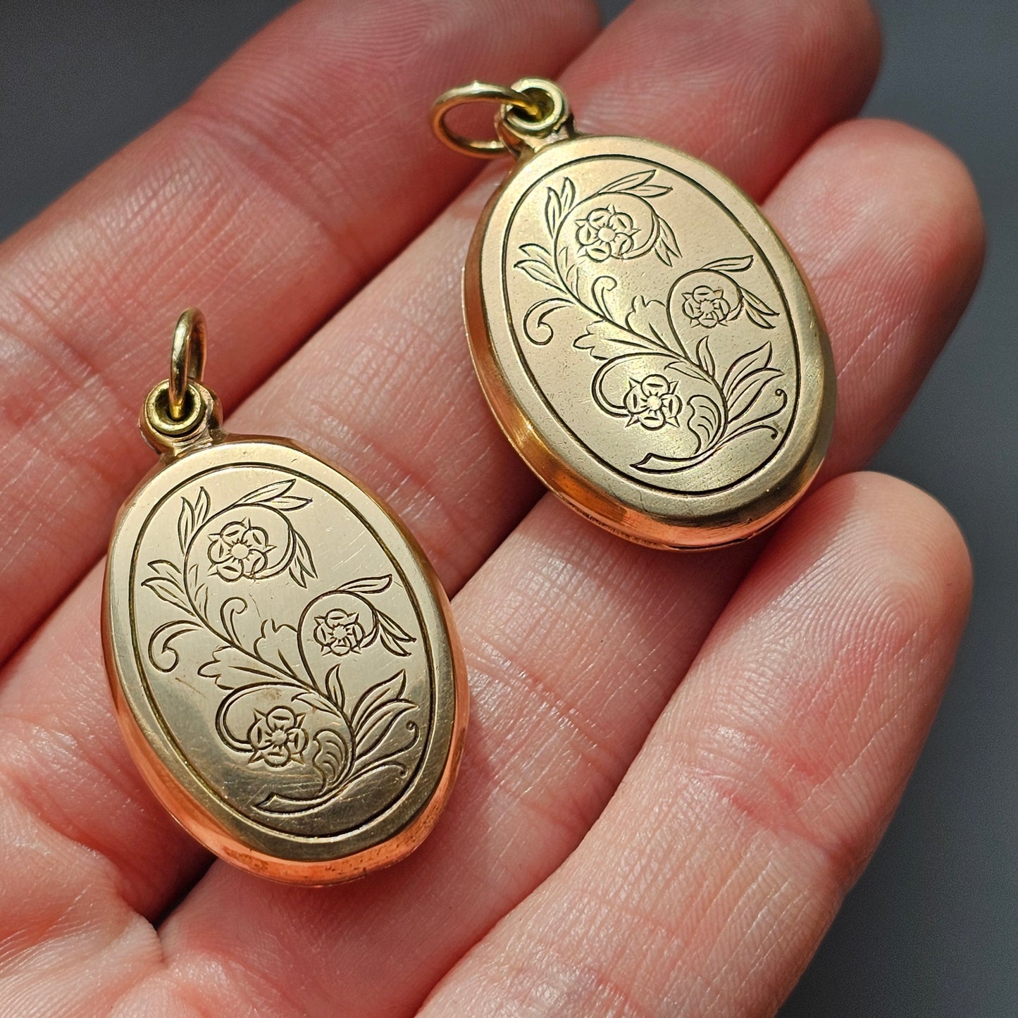 Gold oval lockets with engraved floral designs.