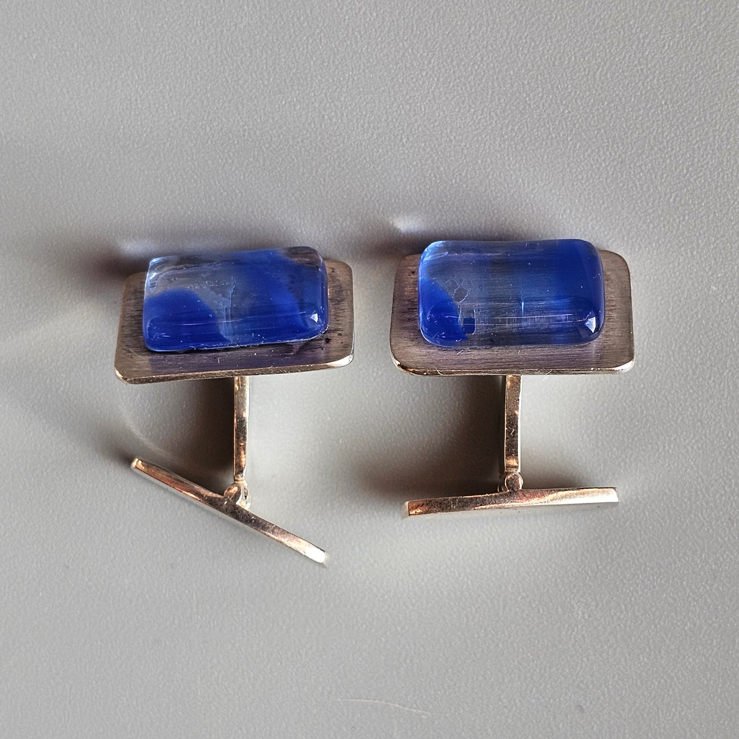 Pair of rectangular cufflinks with blue gemstones or glass inlays.