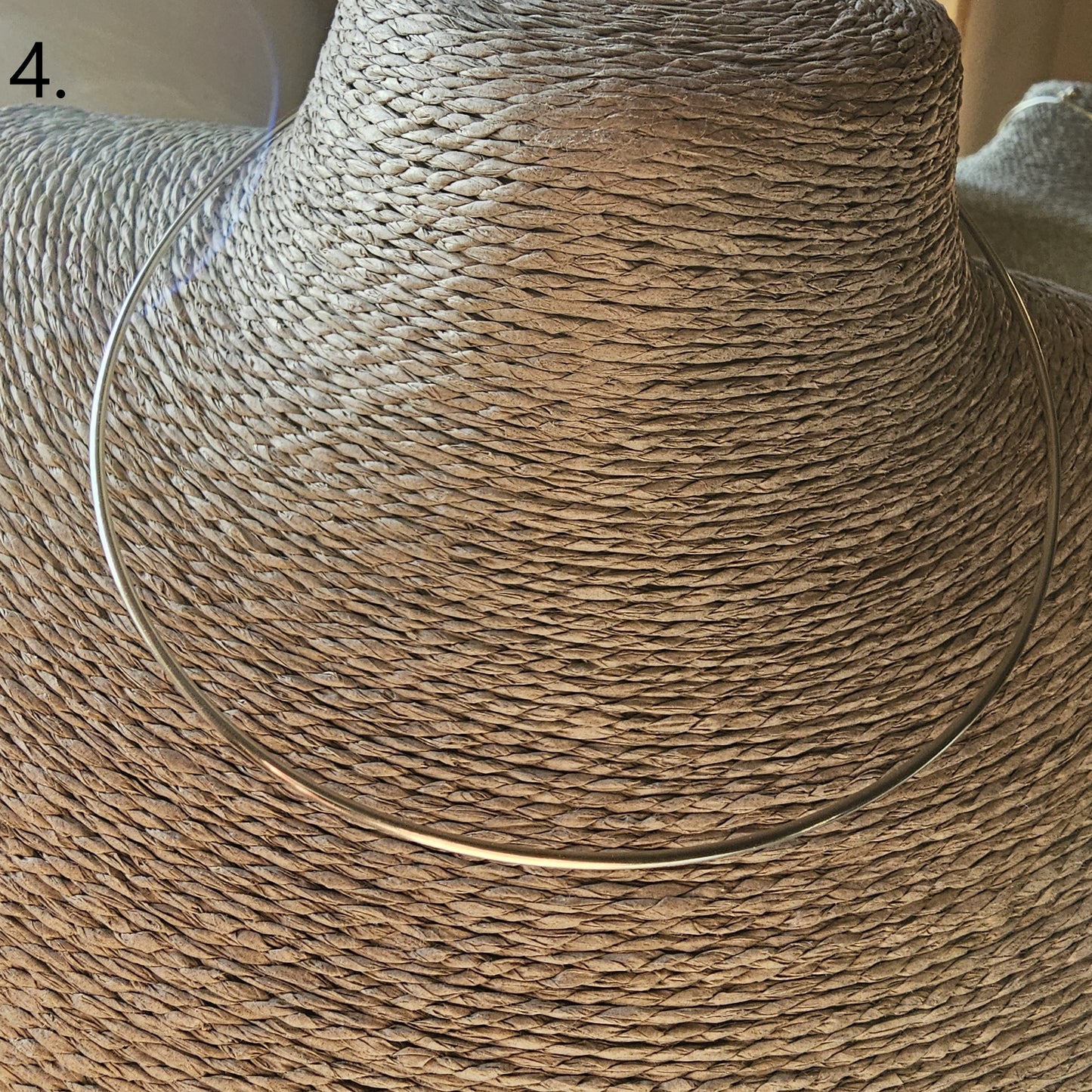 Woven straw sun hat with a wide brim.