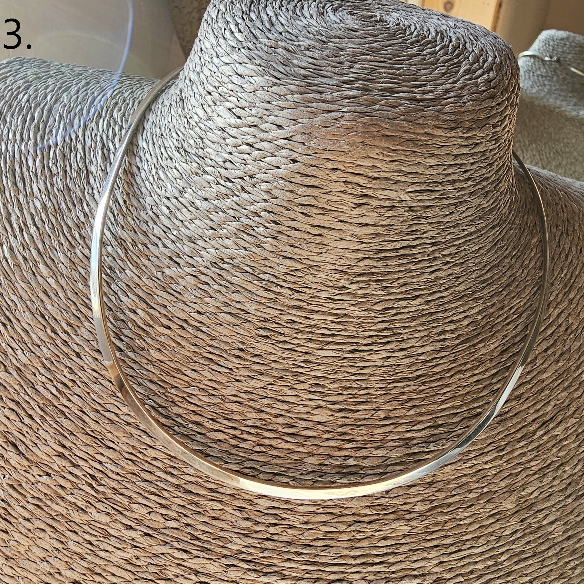 Woven straw sun hat with a wide brim.