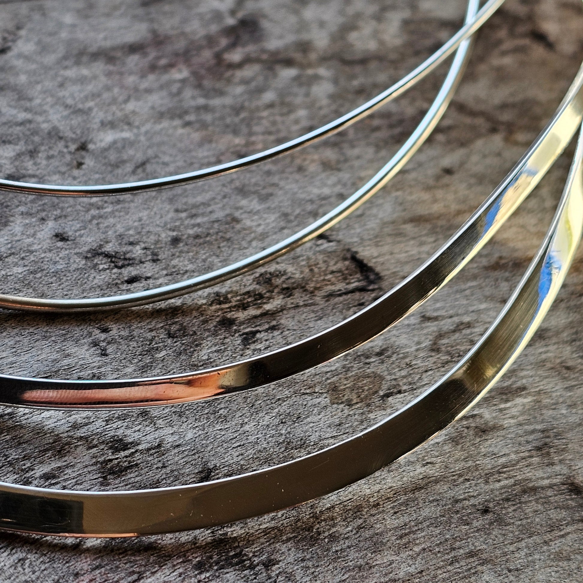 Thin metal wires or strips of varying thicknesses and colors.