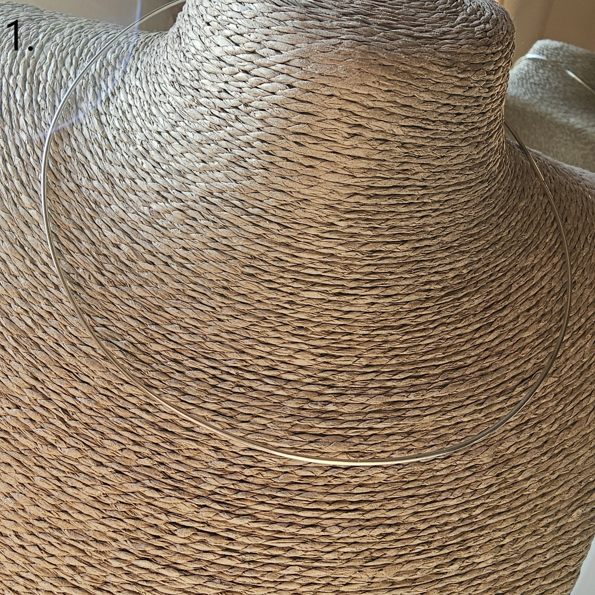 Woven straw sun hat with a wide brim.