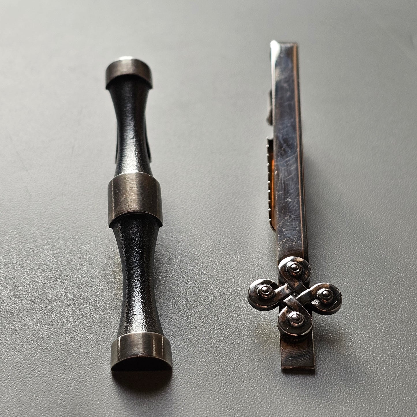 Metal tool with a cylindrical shape and silver-colored ends.