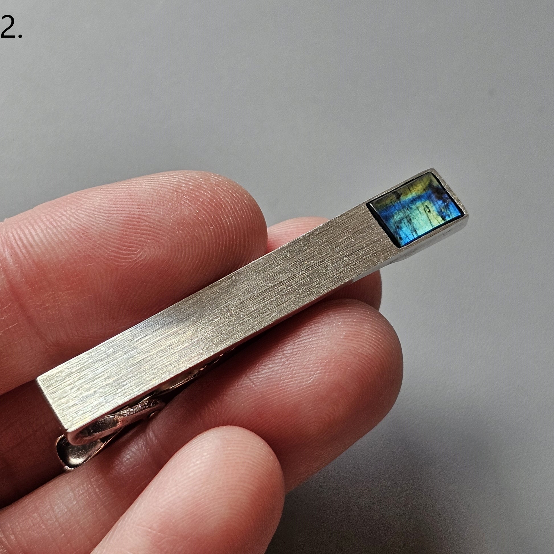 Metallic USB flash drive with a visible blue chip at one end.