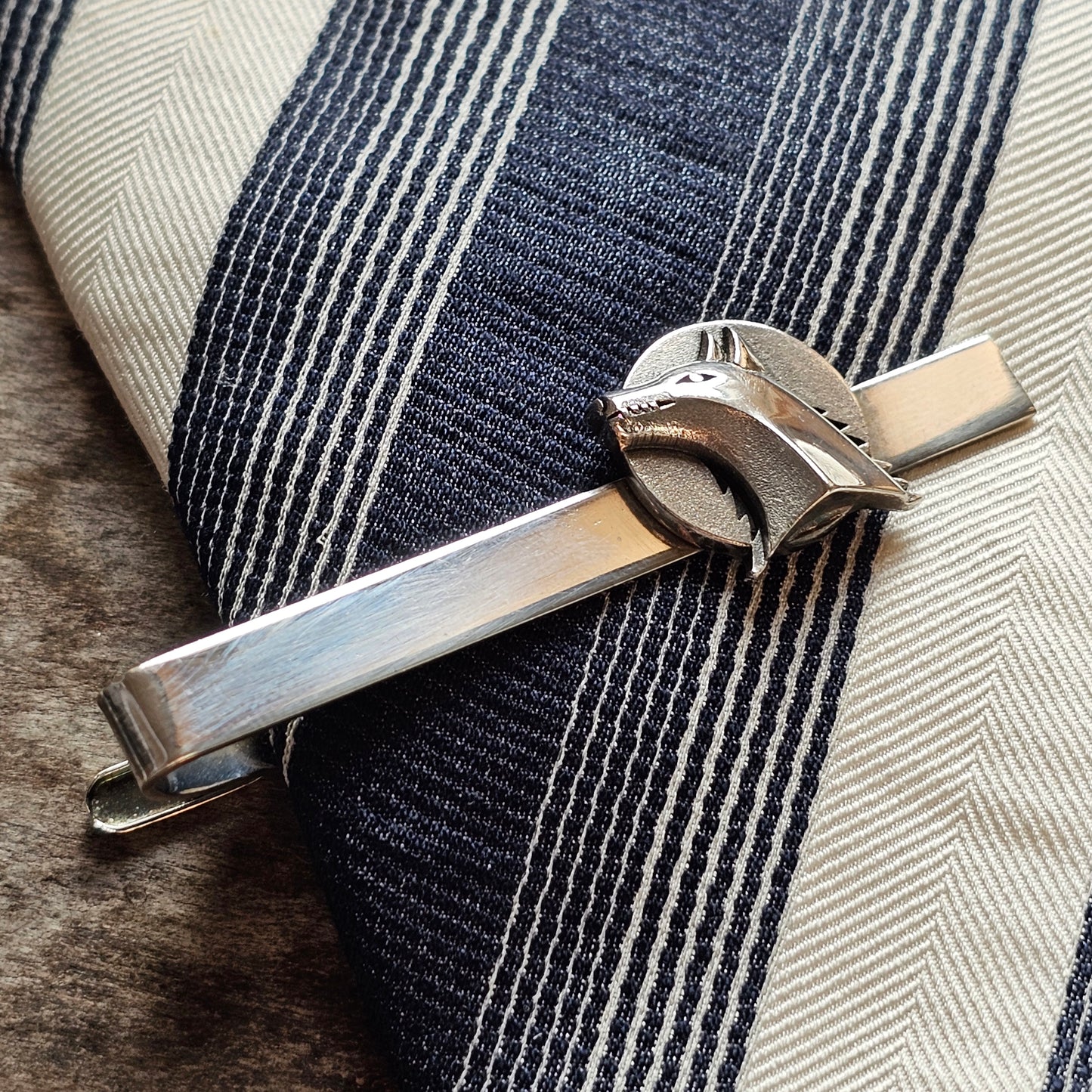 Silver tie clip with a decorative cowboy hat design.