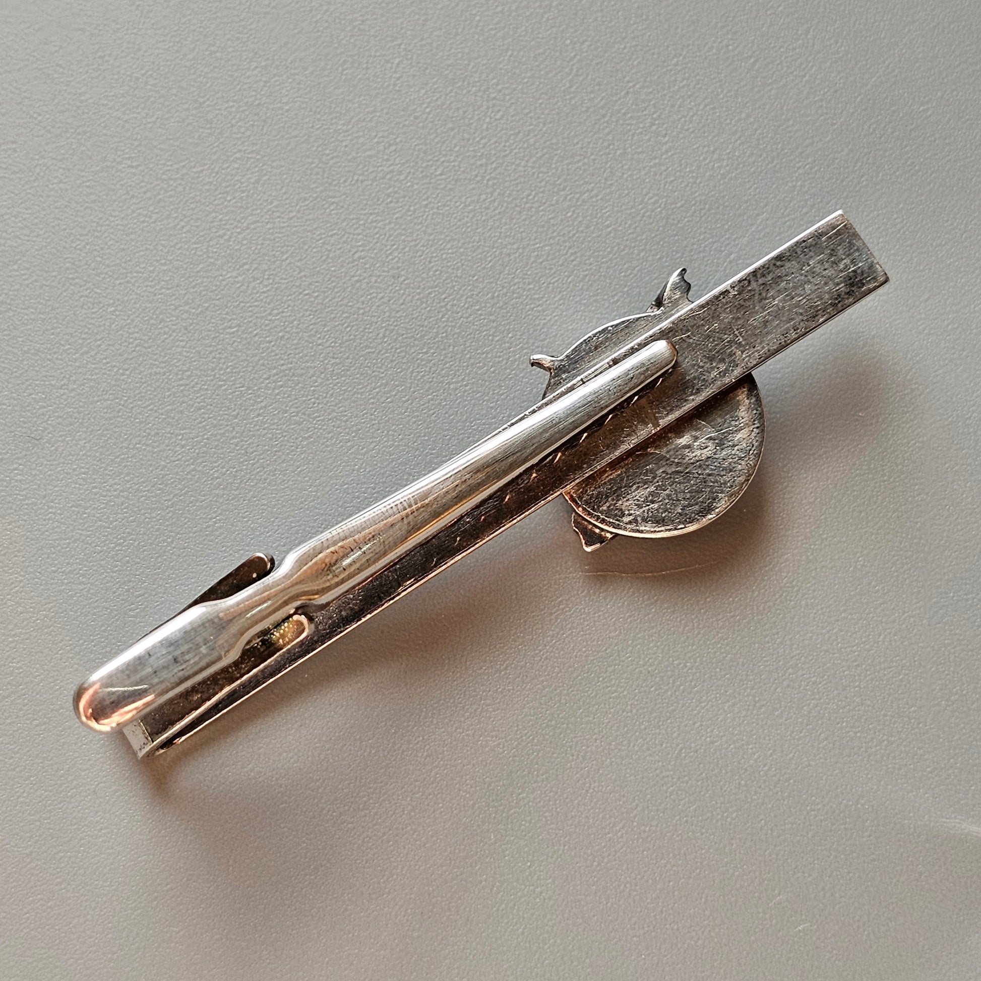 Silver-colored tie clip with a simple, elongated design.