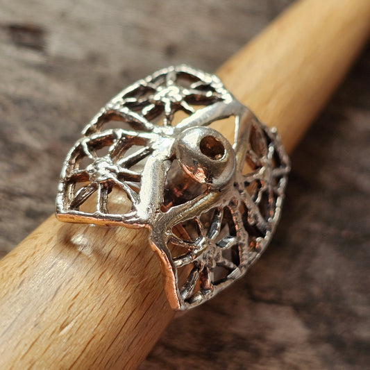 Intricate silver ring with a filigree owl design.