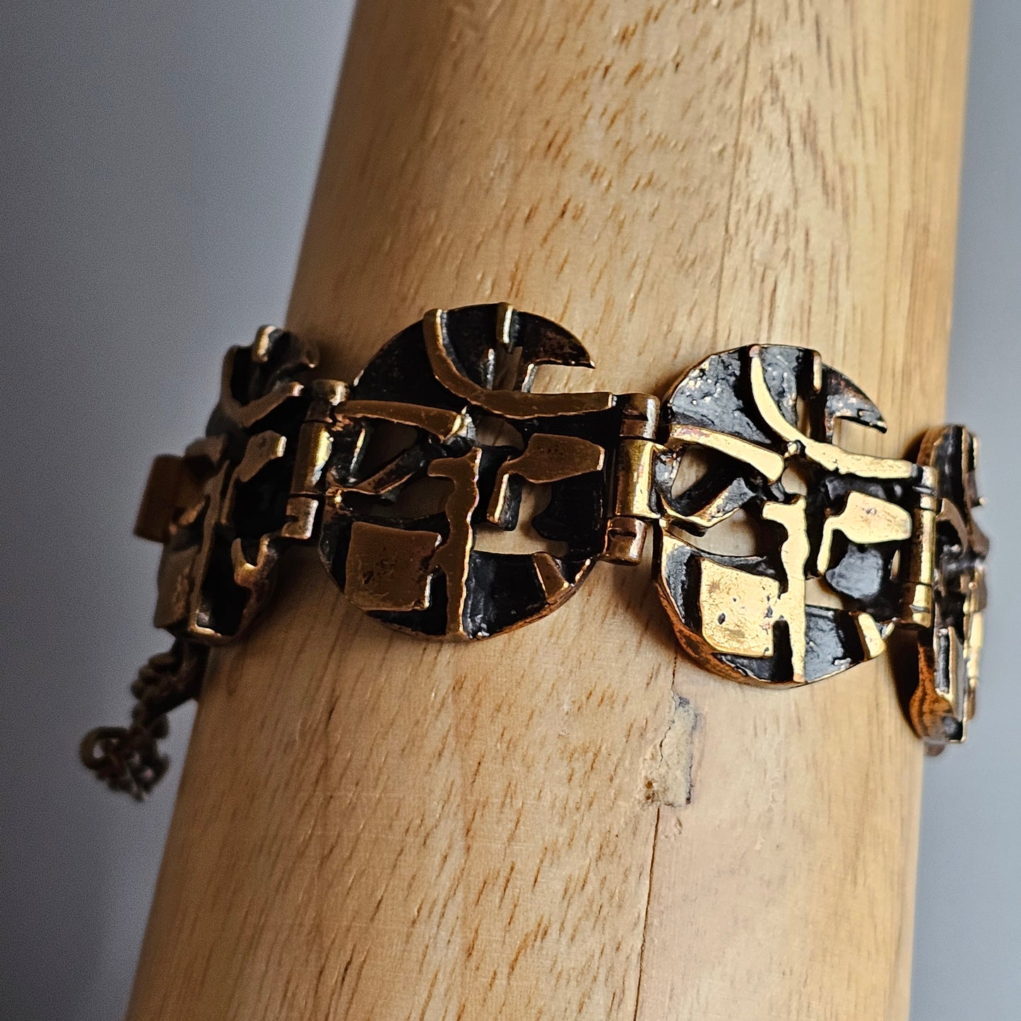 Ornate gold-toned metal bracelet with circular linked segments.