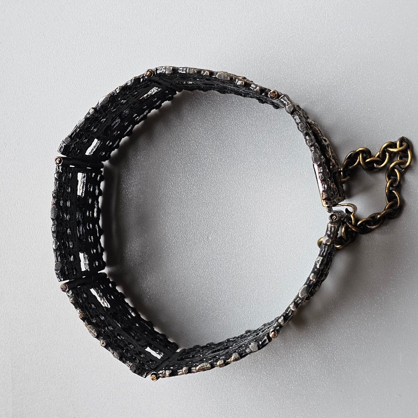 Beaded bracelet with black and silver beads and a metal clasp.