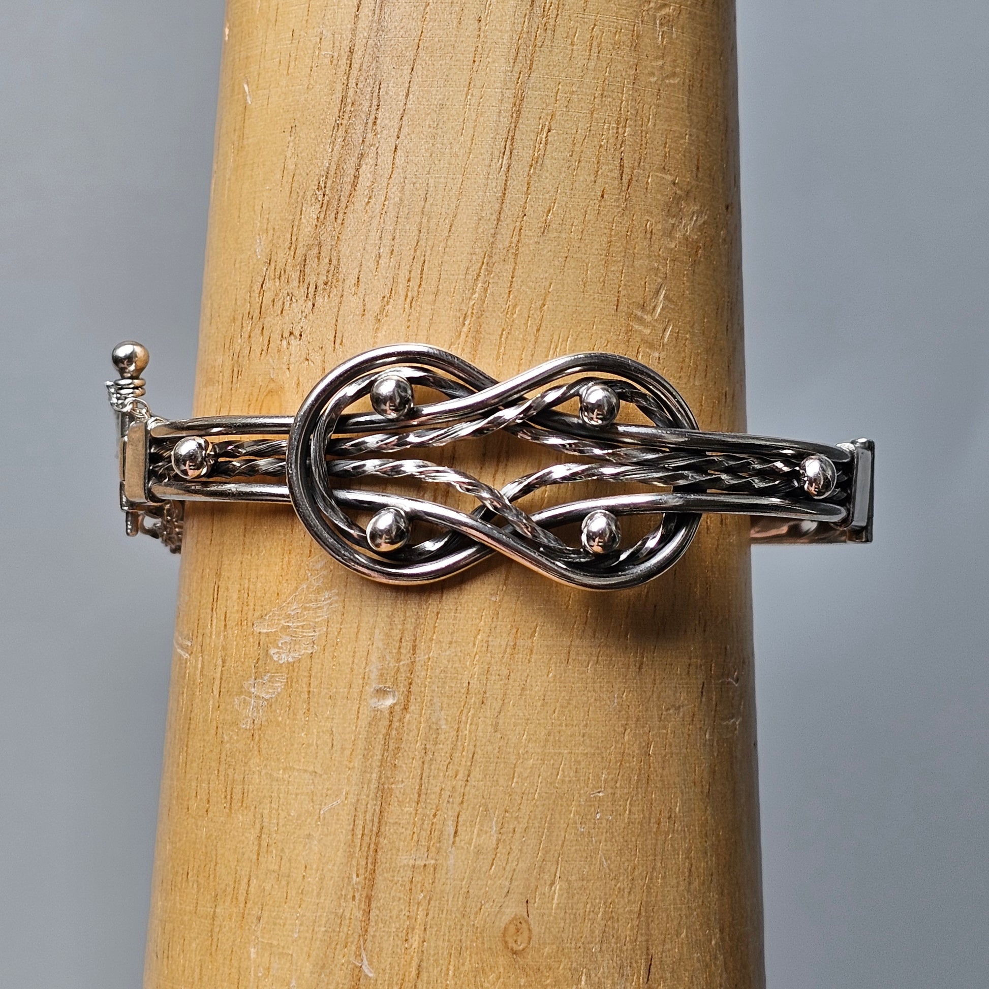 Silver ring with an intricate knot design.