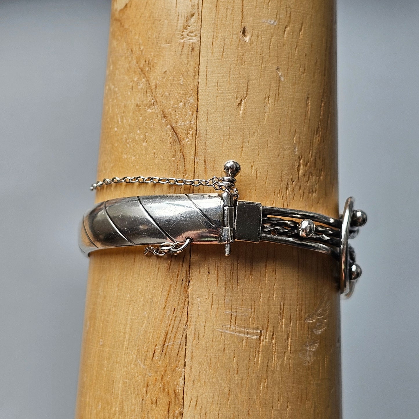 Silver bracelet with a wrapped wire design and a toggle clasp.