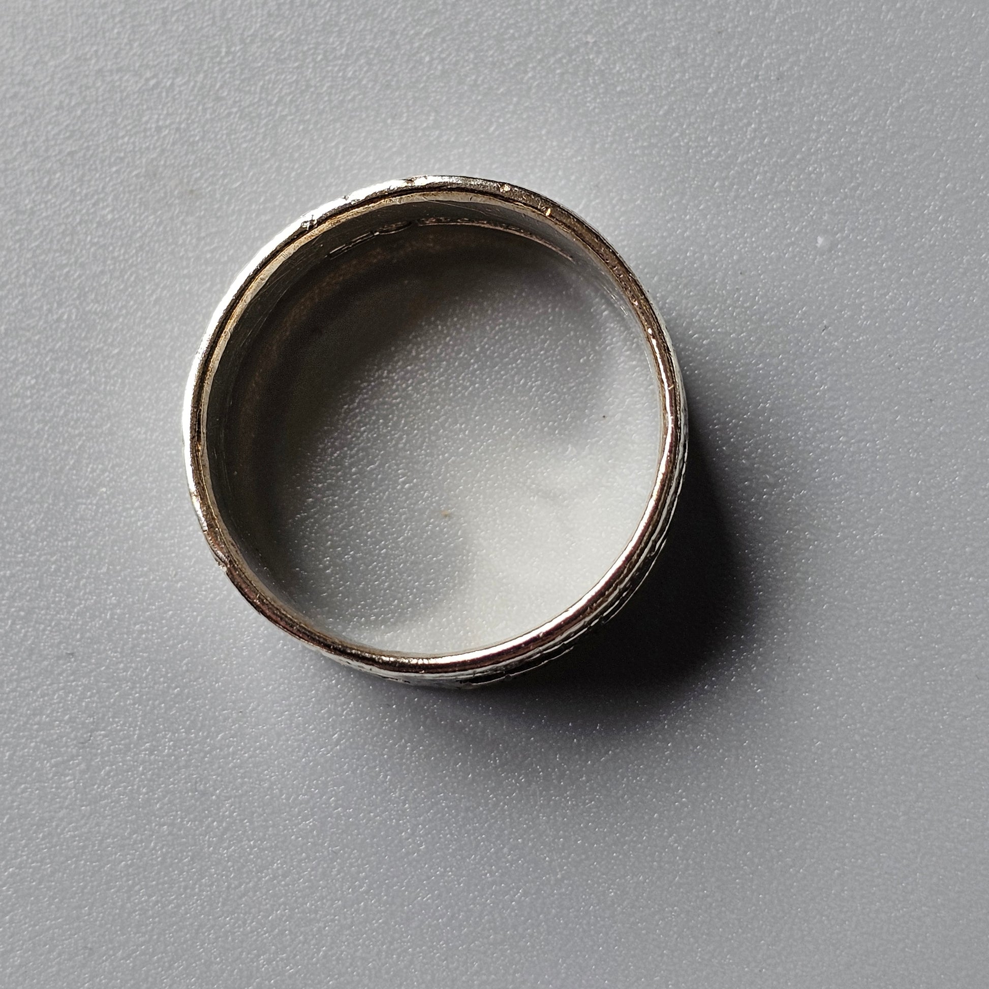 Silver metal ring or band with a plain, unadorned design.