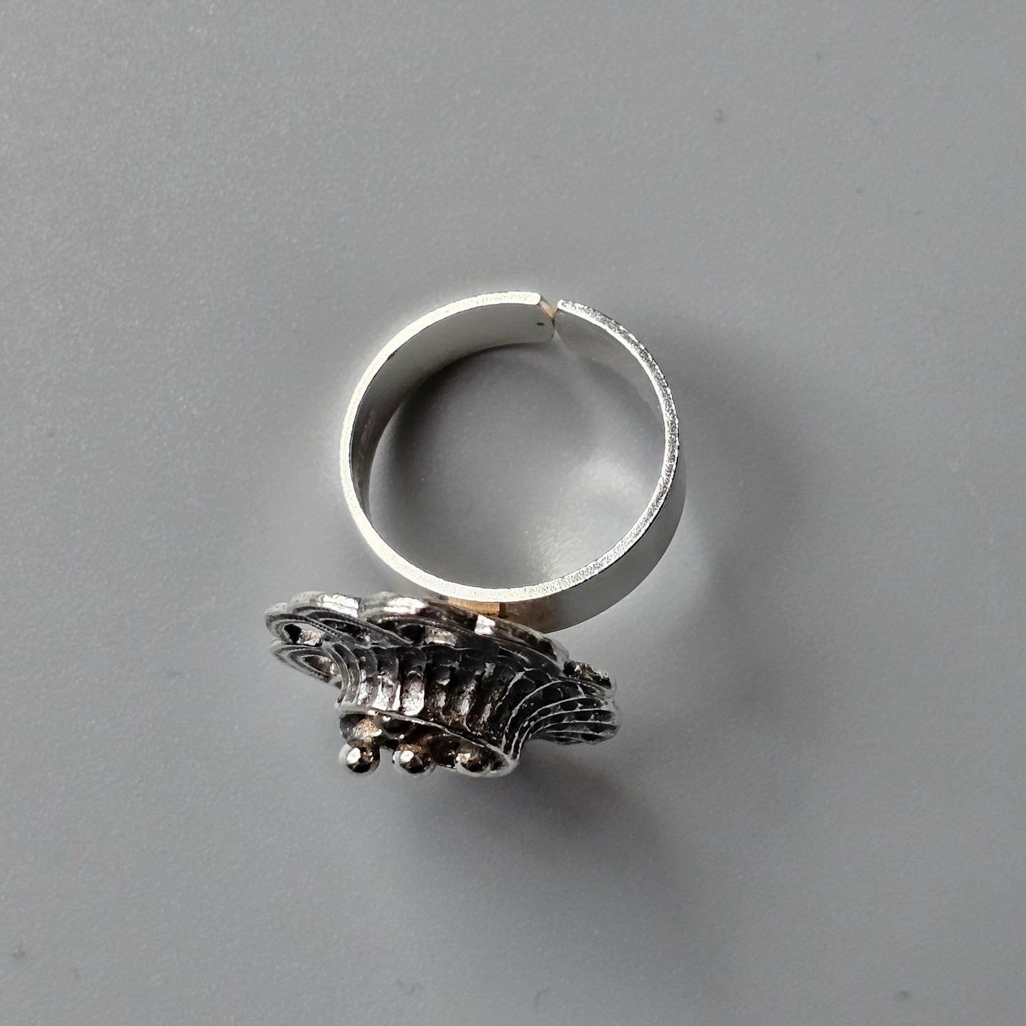 Silver ring featuring an intricate fish-shaped ornament.