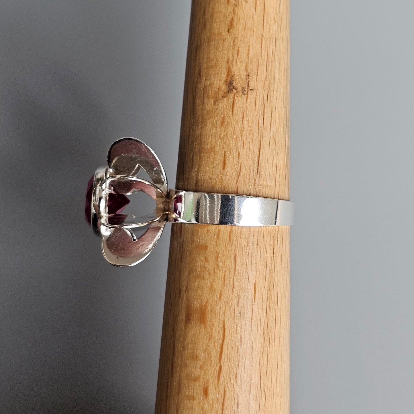 Silver ring with a clear gemstone in a prong setting.