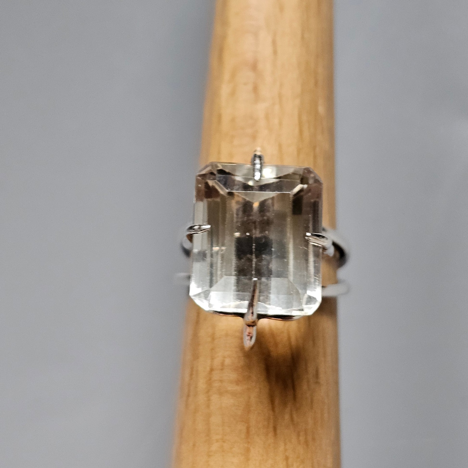 Clear gemstone ring with a rectangular cut and prong setting.