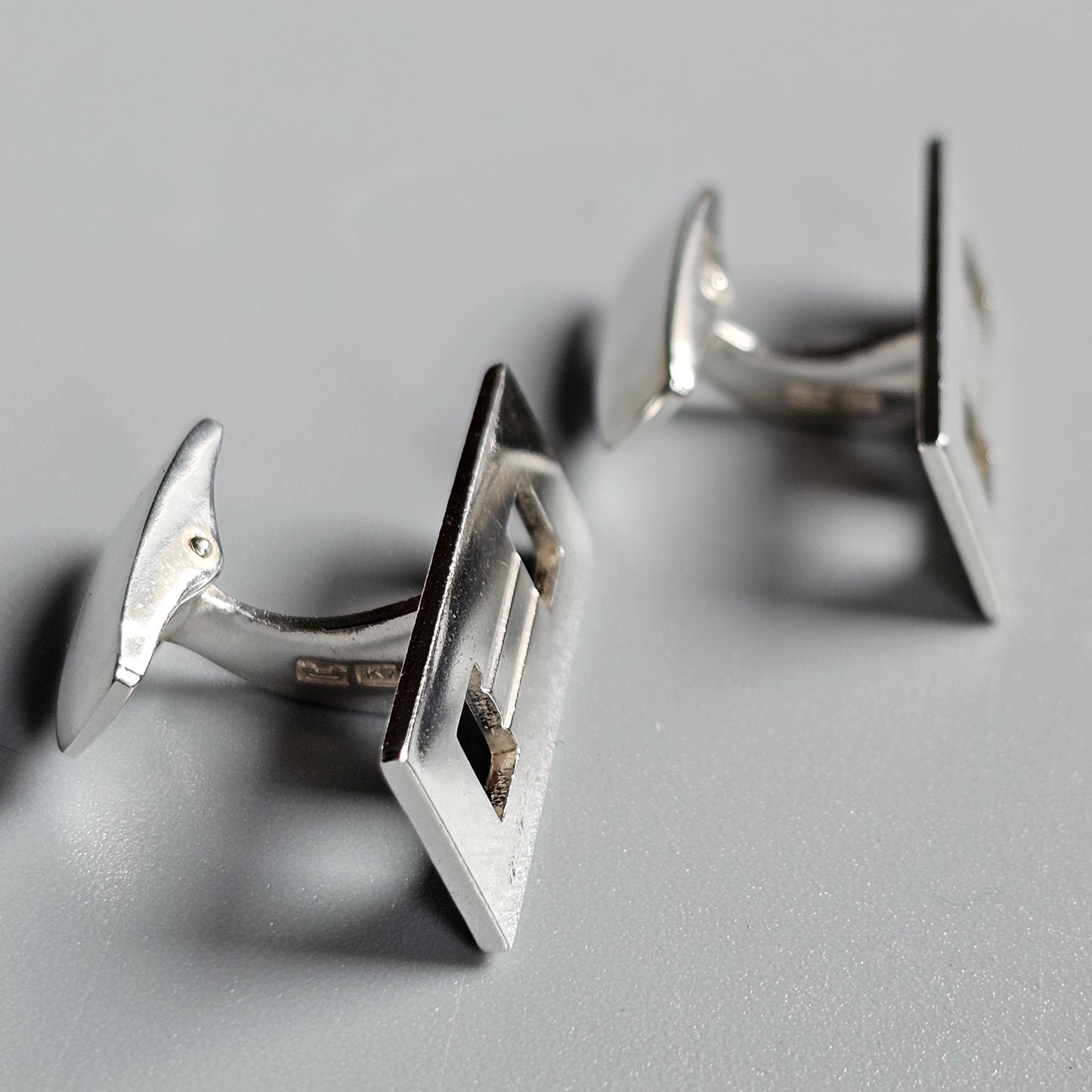 Pair of silver cufflinks with square-shaped faces.