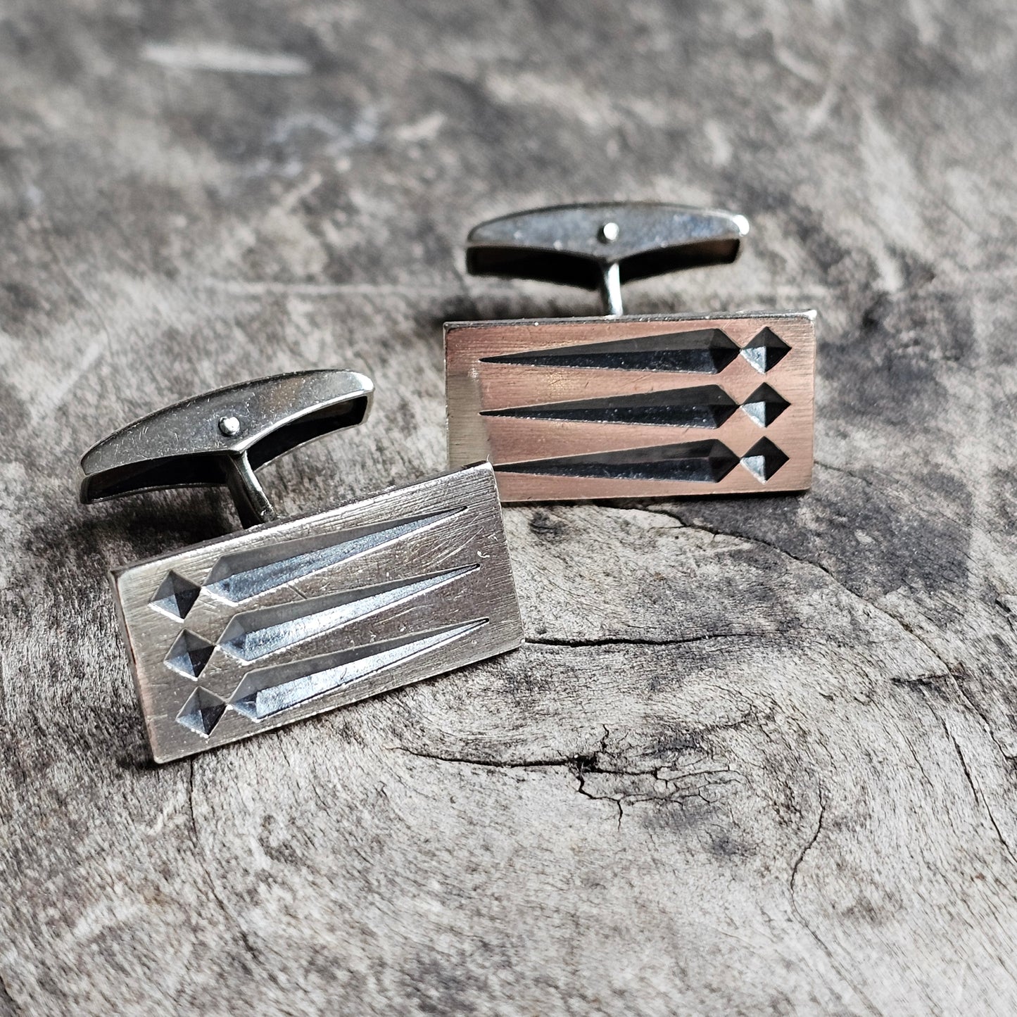 Pair of rectangular metal cufflinks with geometric diamond patterns.