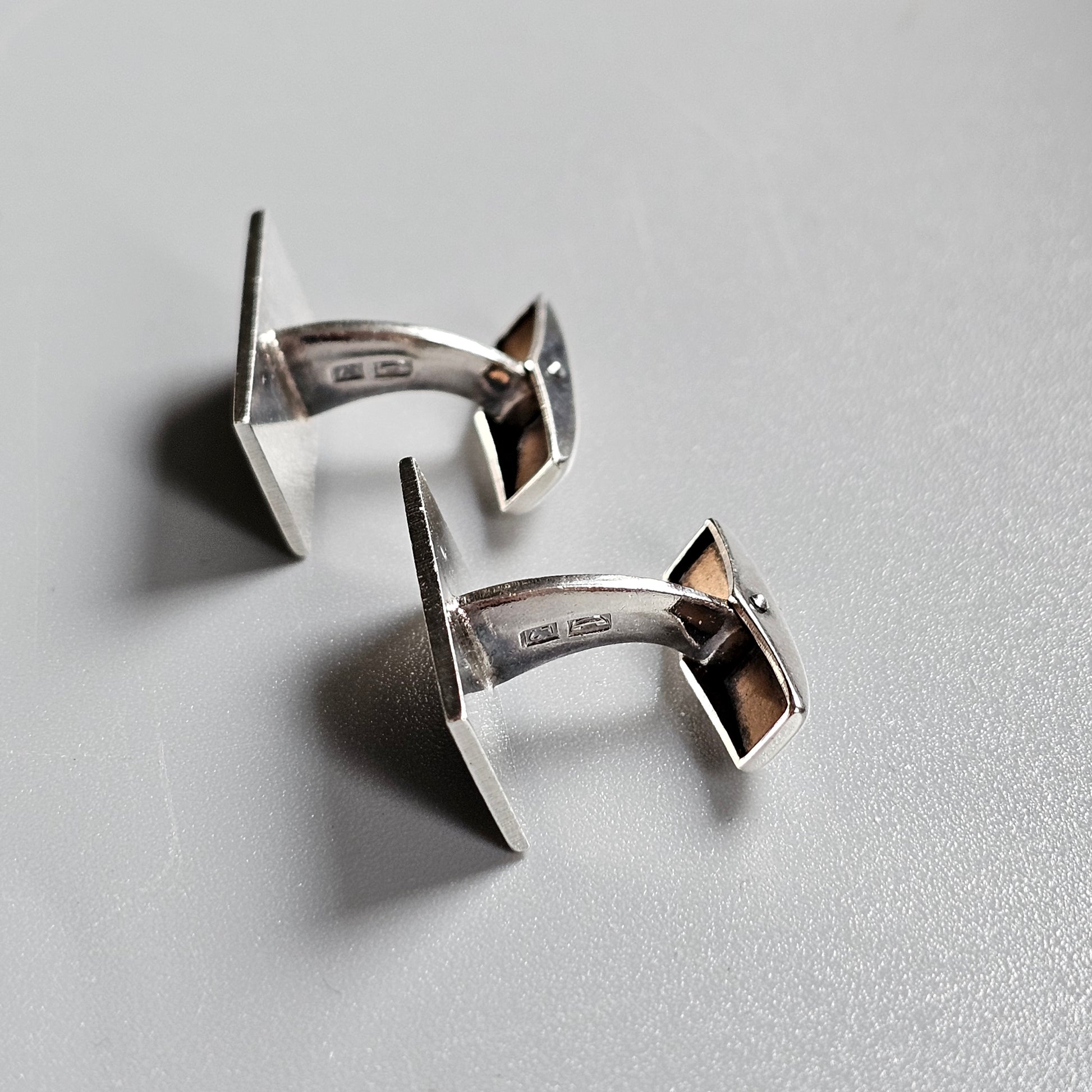 Pair of silver cufflinks shaped like miniature TIE fighters from Star Wars.