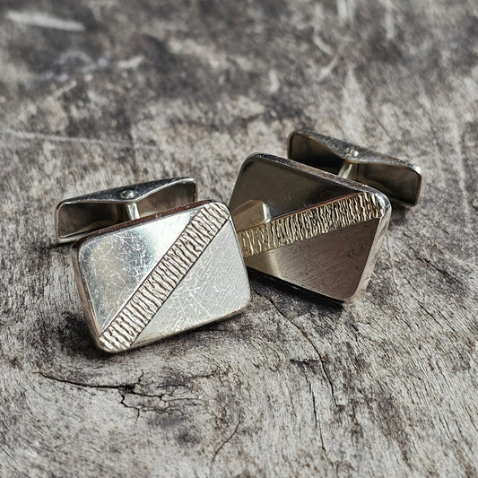 Pair of silver square cufflinks with diagonal textured detailing.