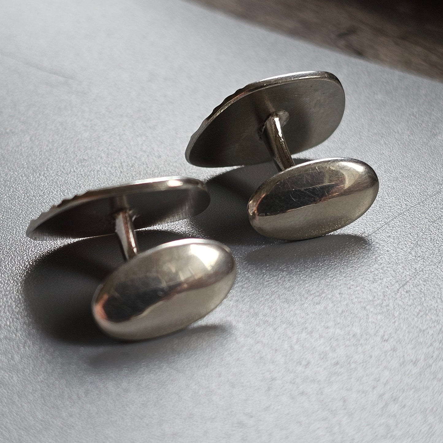 Pair of oval silver cufflinks.