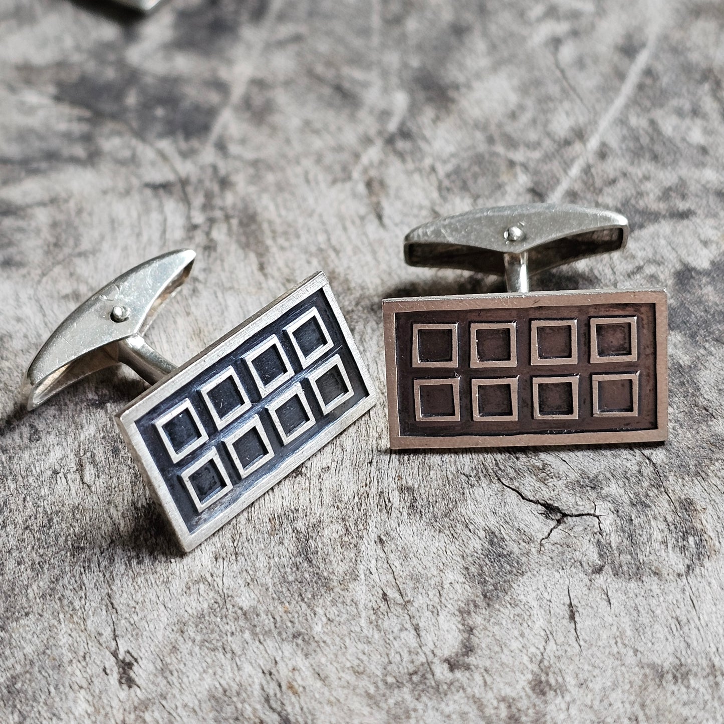 Pair of rectangular cufflinks with geometric grid patterns.