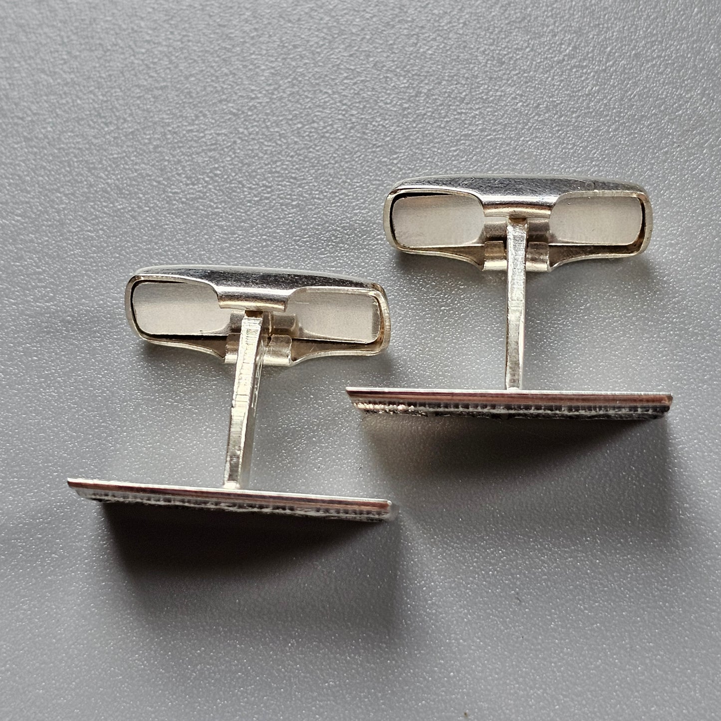 Pair of silver-toned cufflinks with rectangular mother-of-pearl inlays.