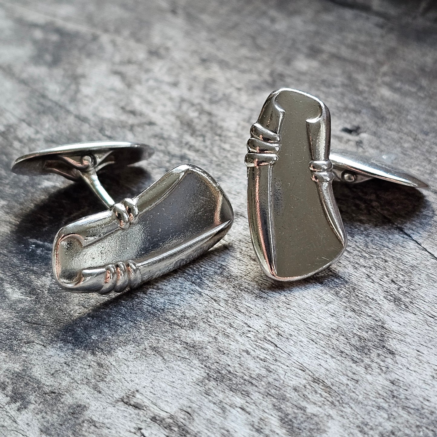 Pair of silver cufflinks with an abstract, modernist design.