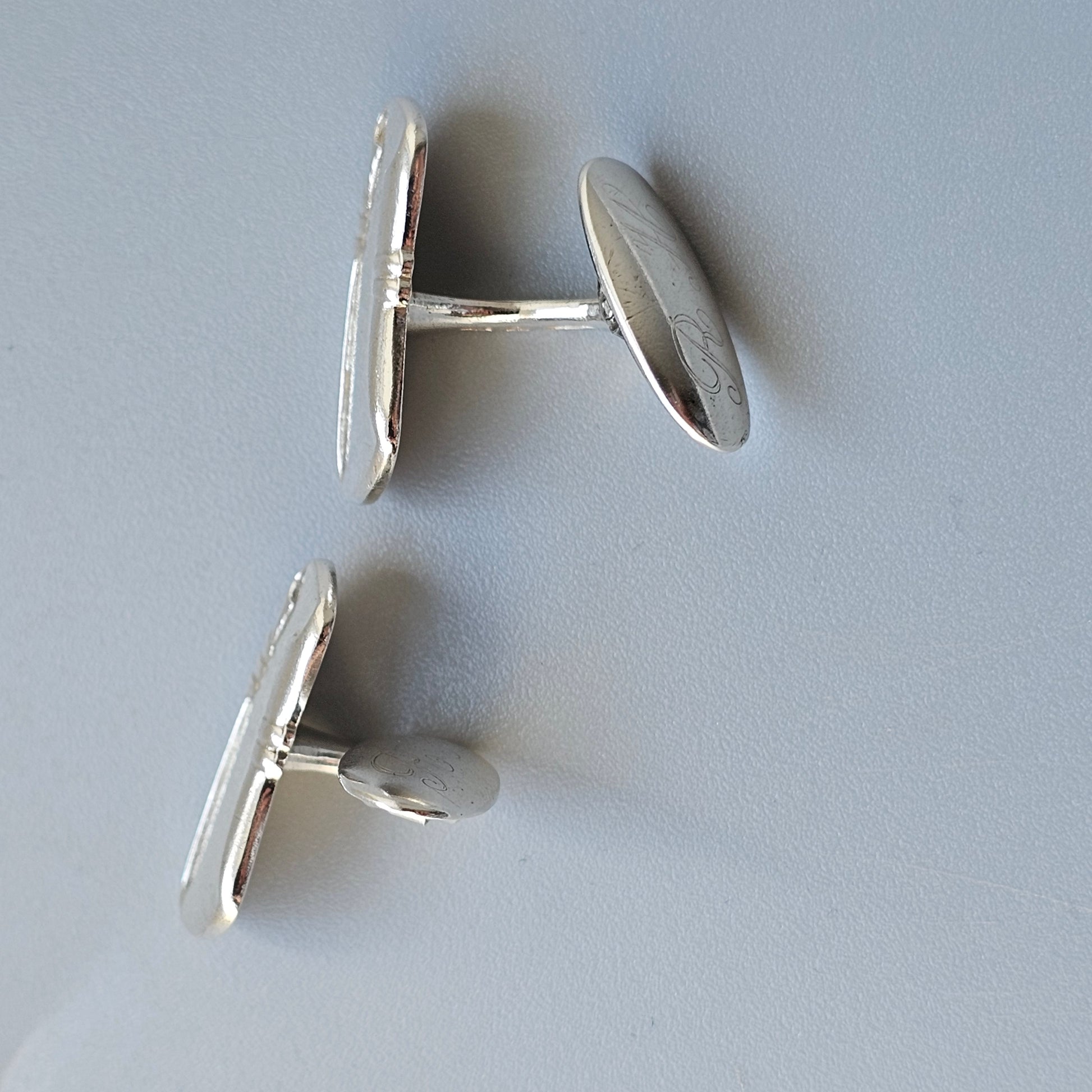 Pair of silver oval cufflinks.