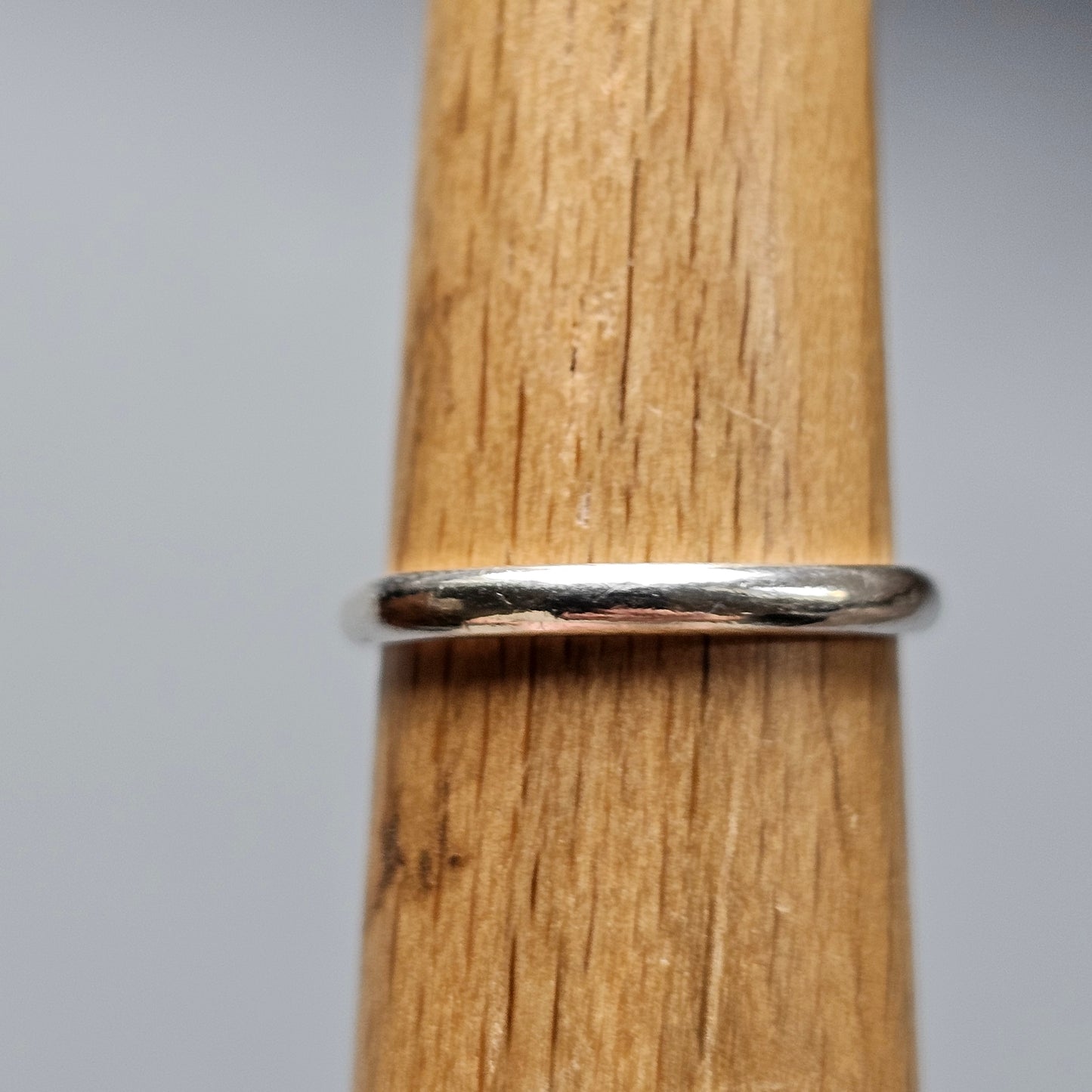 Silver ring with a simple, smooth band design.