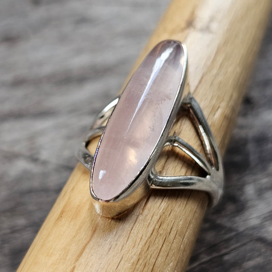 Silver ring with an elongated oval rose quartz gemstone.