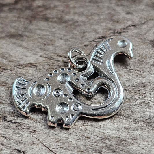 Silver charm pendant shaped like a stylized elephant with decorative patterns.