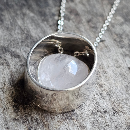 Silver pendant necklace featuring a round moonstone set in a circular bezel.