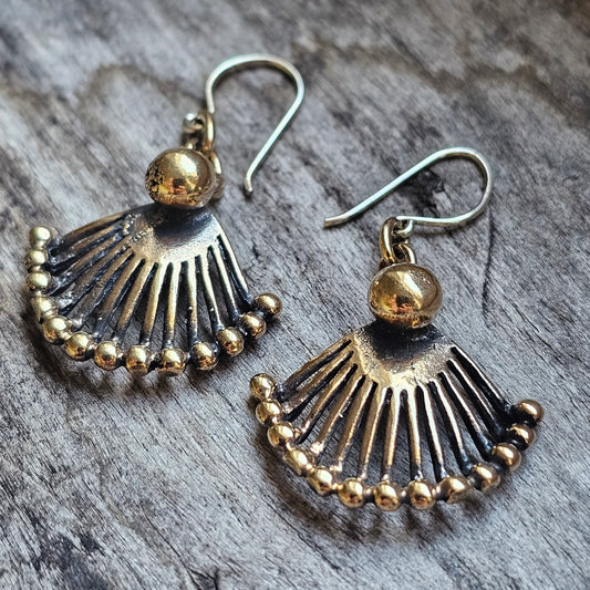 Pair of fan-shaped metallic earrings with dangling beads along the curved edge.