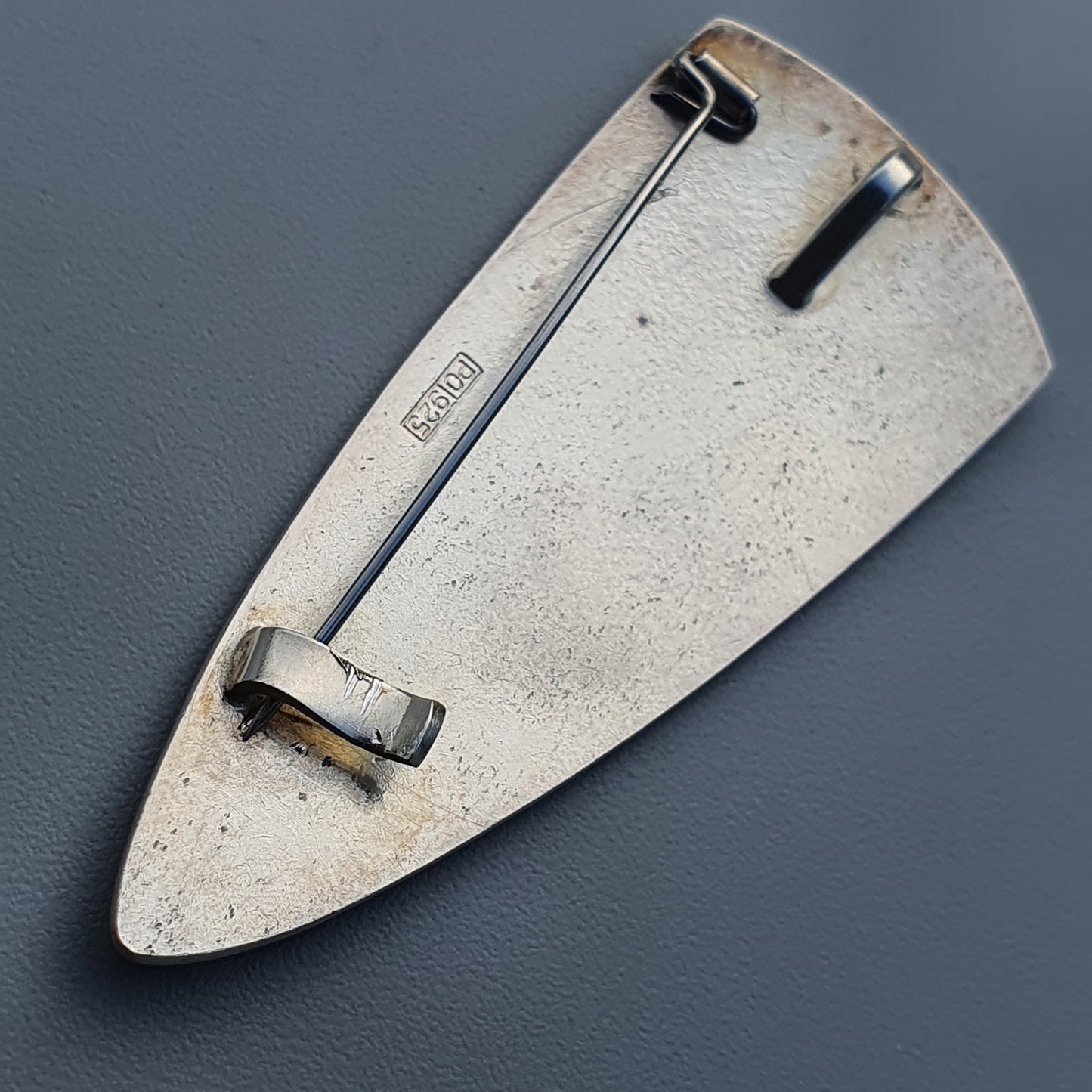 Triangular metal trowel with long handle, featured in Modern Finnish White Enamel Brooch